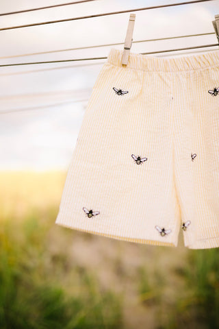 Yellow Seersucker Shorts with Embroidered Honeybees & Black Polo Shirt